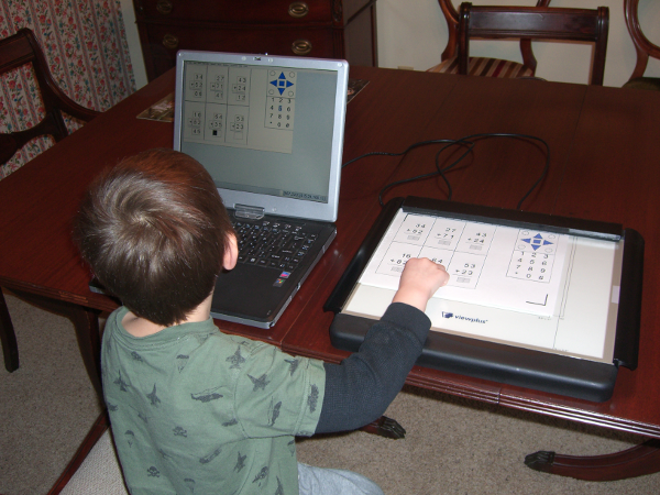 Description: A young person reading an audio-tactile graphic